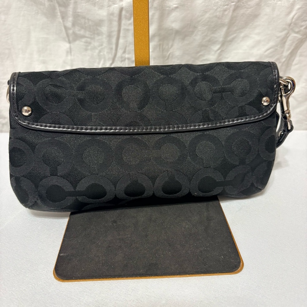 Black clutch wristlet, likely featuring silver-tone hardware - Picture 3 of 7